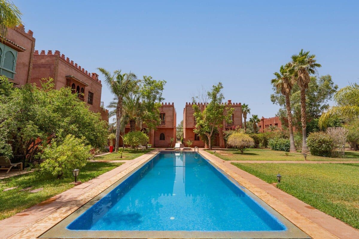 A shared swimming pool at Riad Bab Atlas in Marrakech, reflecting the terracotta architecture — night swims under the stars.