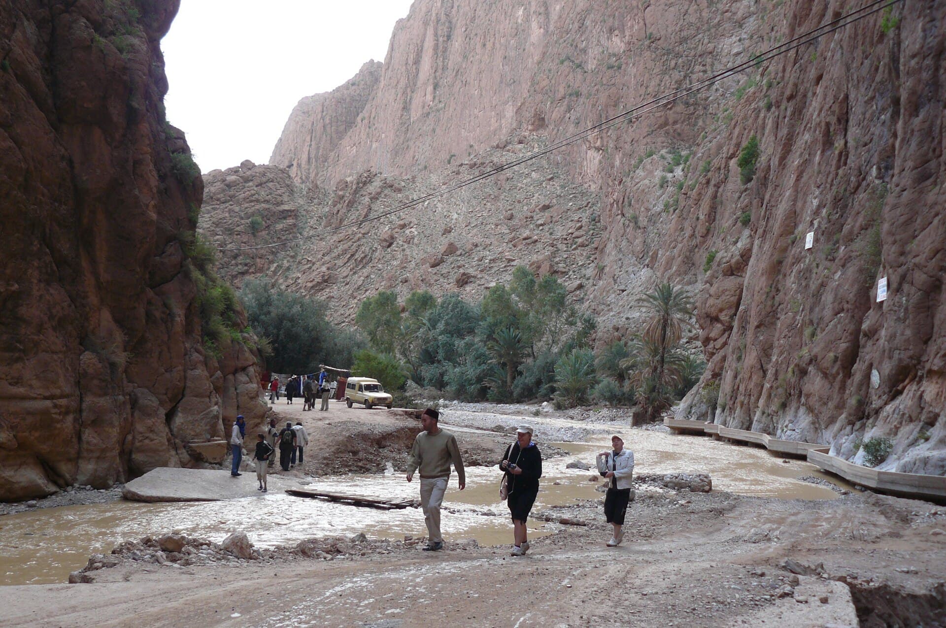 People walking the path between the cliffs of Todra Gorge.