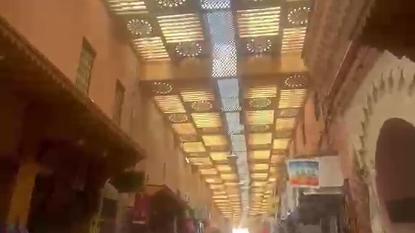 The carved wooden lattice roof over a souk street in Marrakech