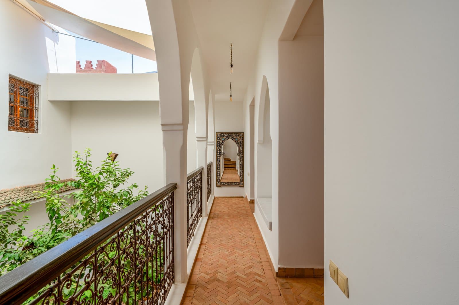 Hall: Upper hallway arches iron railing ornate mirror