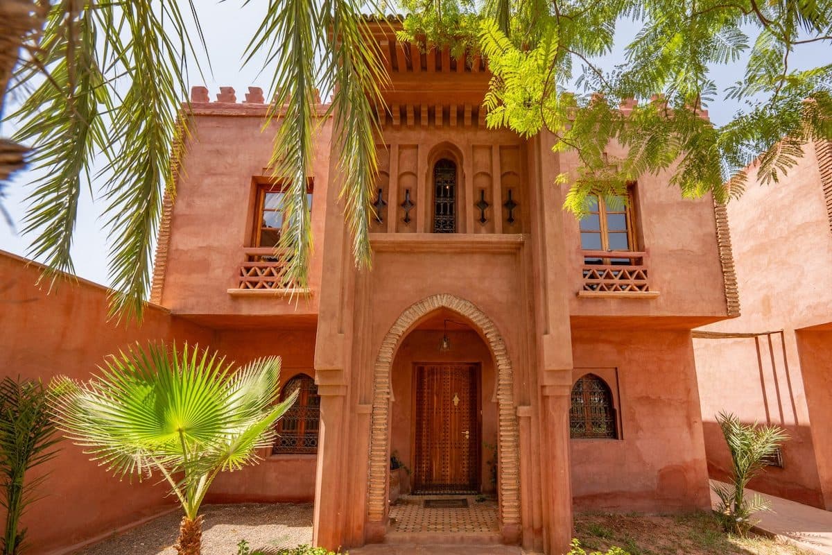 Carved wooden door and crenellated roofline of Riad Bab Atlas.